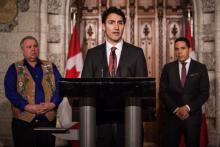 Prime Minister Justin Trudeau, flanked by Manitoba Métis Federation president David Chartrand and Inuit Tapiriit Kanatami president Natan Obed, announces new reconciliation initiatives on Parliament Hill, Thurs. Dec. 15, 2016. Photo by Alex Tétreault