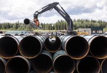 Pipe for the Trans Mountain pipeline is unloaded in Edson, Alta. on Tuesday, June 18, 2019. File photo by The Canadian Press/Jason Franson