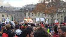 Banner saying “COP 21 +3 Degrees Celsius” on fire at climate protest in Paris, December 12, 2015.  Photo by John Foran