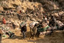 Miners carry bags of ore in the copper-cobalt Shabara artisanal mine near the town of Kolwezi, Lualaba, in the Democratic Republic of Congo, on June 20, 2023. ARLETTE BASHIZI / FOR THE WASHINGTON POST VIA GETTY IMAGES