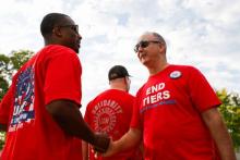 United Auto Workers president Shawn Fain shakes hands with a union member before marching in the Detroit Labor Day Parade on September 4, 2023., (Bill Pugliano / Getty Images)