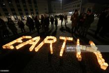 Participants attend Earth Hour 2018 in front of the Brandenburg Gate on March 24, 2018 in Berlin. Adam Berry/Getty Images.
