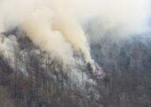 Smoke rises from wildfires in the Great Smoky Mountains near Gatlinburg, Tenn., on Tuesday. Great Smoky Mountains National Park