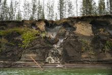 Permafrost, seen at the top of the cliff, melts into the Kolyma River outside of Zyryanka, Russia, in July 2019. A new study has found that methane is being released not only from thawing wetlands but also from thawing limestone. (Michael Robinson Chavez/The Washington Post)