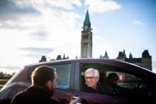 Natural Resources Minister Jim Carr listens to a question from Winnipeg Free Press reporter Dylan Robertson in Ottawa on April 8, 2018, in a Nissan Leaf driven by the minister's chief of staff, Zoe Caron. Photo by Alex Tétreault