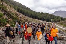 Forest defenders march into Waterfall Camp near Fairy Creek Valley in June 2021. (Photo by Alex Harris)