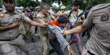 Security personnel detain a protestor during a march towards Parliament on July 20. Photo: PTI.