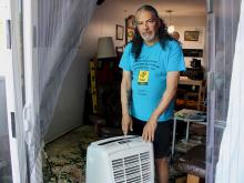 Ryan Le Neal with his small portable air conditioner. Tenants at his building in New Westminster were warned by their landlord that using an air conditioner could breach their tenancy agreements. Photo by Jen St. Denis.