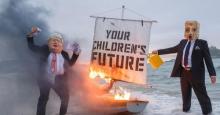 Ocean Rebellion staged a theatrical action with a Boris Johnson head and an "Oil head" burning a boat on Marazion beach on June 5, 2021 in Cornwall, United Kingdom. (Photo: Gav Goulder/In Pictures via Getty Images)