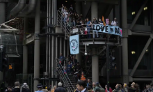 Extinction Rebellion protesters play drums outside Lloyd’s of London as they blocked the entrances to its headquarters. Photograph: Matt Dunham/AP