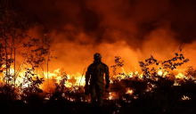 A firefighter sets fire to land in an attempt to prevent wildfires from spreading in Gironde, south-west France. A rise in global temperature of 1C to date has already contributed to climate disasters. Photograph: Thibaud Moritz/AFP/Getty Images