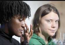 Climate activist Vanessa Nakate of Uganda, left, reacts beside Greta Thunberg of Sweden at a press conference at the World Economic Forum in Davos, Switzerland on Thursday, Jan. 19, 2023. Photo by The Associated Press/Markus Schreiber