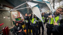 City of Vancouver employees work to dismantle tents in the Downtown Eastside neighbourhood of Vancouver on Wednesday, April 5, 2023. (Ben Nelms/CBC)