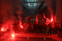 Railway workers and others storm a building containing an office for U.S. financial company BlackRock on Thursday in Paris.VIA ASSOCIATED PRESS