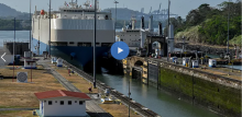 A ship is guided through the Panama Canal's Miraflores locks near Panama City