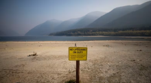 People walk along the shore of Alouette Lake amid drought conditions on Tuesday, Oct. 18, 2022. (Ben Nelms/CBC)