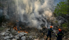 Firefighters try to control a wildfire in New Peramos, near Athens, Greece. Photograph: Louisa Gouliamaki/AFP/Getty Images
