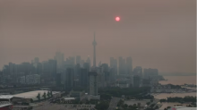Toronto in smoke - A new government-commissioned report on the risks Ontario faces from climate change has been made public after a summer that included stretches of extreme heat, heavy rainstorms and unprecedented wildfire smoke, seen in this view of Toronto in June. (Patrick Morrell/CBC)