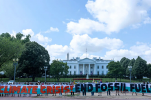Climate activists chant as they occupy Lafayette Park with a banner demanding President Biden act on climate change near the White House on July 04, 2023 in Washington, DC. Tasos Katopodis—Getty Images