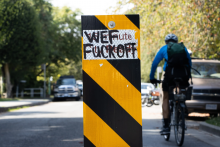 For months, Vancouver's road signs have been defaced by conspiracy theorists plastering them with references to conspiracies about 15-minute cities and the World Economic Forum. Photo by Marc Fawcett-Atkinson/National Observer