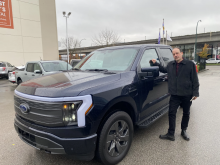 Chris Pollon is dwarfed by the EV version of the Ford F-150 Lightning, which is not only big — it's heavy. Photo submitted