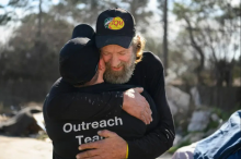 Slim hugs Jessalyn Dimanno, the manager of outreach for the Coalition for the Homeless. CALLAGHAN O’HARE / FREE PRESS
