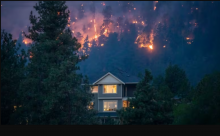 A wildfire burns near a home in the city of Kelowna, B.C., on Aug. 18, 2023. An internal RCMP report warns that a series of geopolitical and national threats — including climate change — will test the ability of governments and police services to protect Canadians in the coming years. (Ben Nelms/CBC)