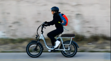 Woman riding an electric bike in Denver. Photo by Getty Images/Grist
