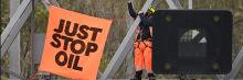 An activist puts up a banner reading "Just Stop Oil" atop an electronic traffic sign along M25 on November 10, 2022 in London, United Kingdom. (Photo: Leon Neal/Getty Images)
