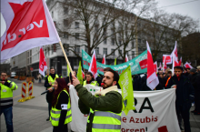 Striking public transport workers and activists from the Fridays For Future climate movement walk with flags during a protest on March 3, 2023 in Hanover, Germany. ALEXANDER KOERNER / GETTY IMAGES