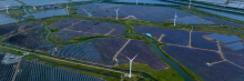 Wind turbine blades and connected photovoltaic panels are seen in the tidal flat wetland of Yancheng City, Jiangsu province, September 23, 2023. (Photo by Costfoto/NurPhoto via Getty Images)