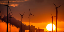 A coal-fired power plant operates near wind turbines in Niederaussem, Germany. Photograph: Michael Probst/AP