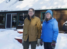 Richard Kabzems and Sandra Burton stand outside their home a short distance from a gas well pad where they fear fracking operations could trigger damaging and potentially deadly earthquakes. Photo by The Tyee.