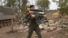 An Israeli soldier carries mortar shell cases in southern Israel, near Gaza, on Nov. 25, 2023. Tax and shipping records appear to say Canadian companies have continued to ship ammunition and other materiel to Israel despite Ottawa's claims to the contrary. (Tsafrir Abayov/The Associated Press)