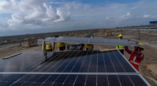 Workers install solar panels in the western state of Gujarat, India, in 2023. India saw record solar and wind power generation growth that outpaced the growth in demand in the first half of this year, according to a report by the global energy think-tank Ember. (Rafiq Maqbool/The Associated Press)