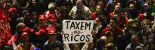 People attend a demonstration in support of taxing the super-rich in São Paulo, Brazil on July 10, 2025. (Photo by Miguel Schincariol/AFP via Getty Images)