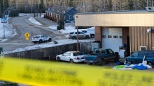 Police seen at Tumbler Ridge Secondary School Wednesday morning following a mass shooting. After police identified the suspect as a transgender teen, trans advocates say some have used the shooting as an excuse to spread hate against their community online. (Jesse Boily/The Canadian Press)