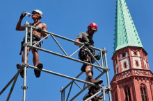 A worker drinks water as he sets up a stage for the upcoming Ironman triathlon, Frankfurt, Germany, on Thursday, June 25, 2026. File photo by: The Associated Press/Michael Probst