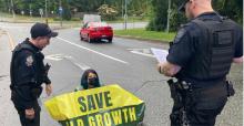 Photo©SaveOldGrowth - protester in road 