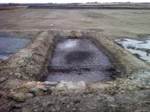 Diana Daunheimer found this large sump pit, or dugout designed to store drilling waste, at a wellsite northeast of her property in July 2012. Photo: Diana Daunheimer.