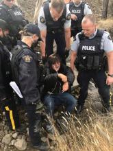 Police arrest a protester at Trans Mountain's Mission Flats worksite on Oct. 15. Photograph By FACEBOOK